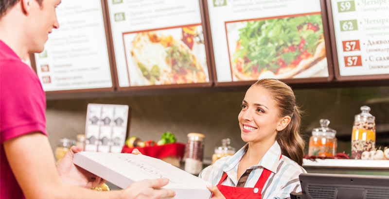 A Tim Horton's employee serving a customer