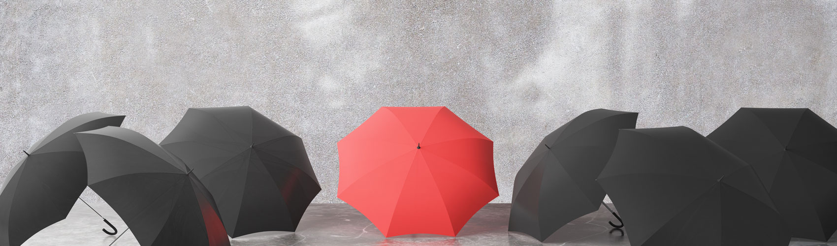 Six black and 1 reb umbrella sitting on the sideawalk